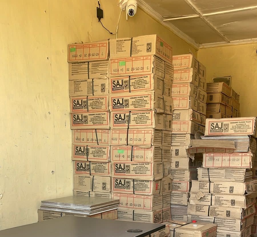 Boxes of ceramic floor tiles stacked inside the shop