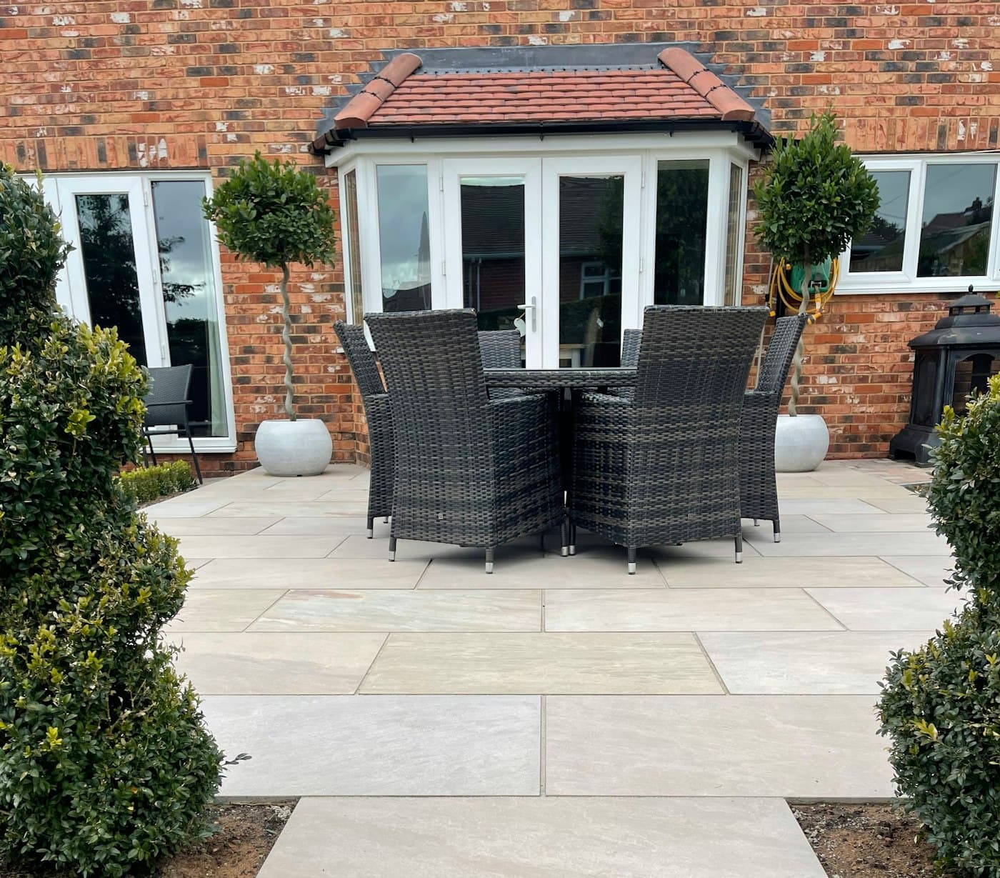 Illustrative photo: tiled patio with outdoor furniture